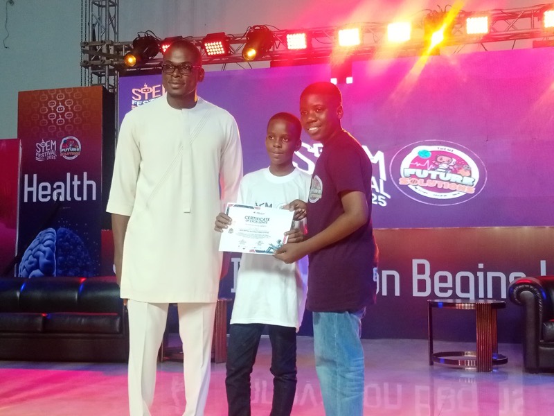 A Nibi's Tech student receiving a certificate on stage at the STEM Festival 2025